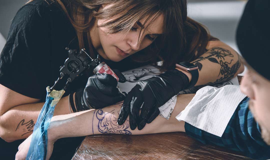 Tattoo apprentice in a tattoo studio